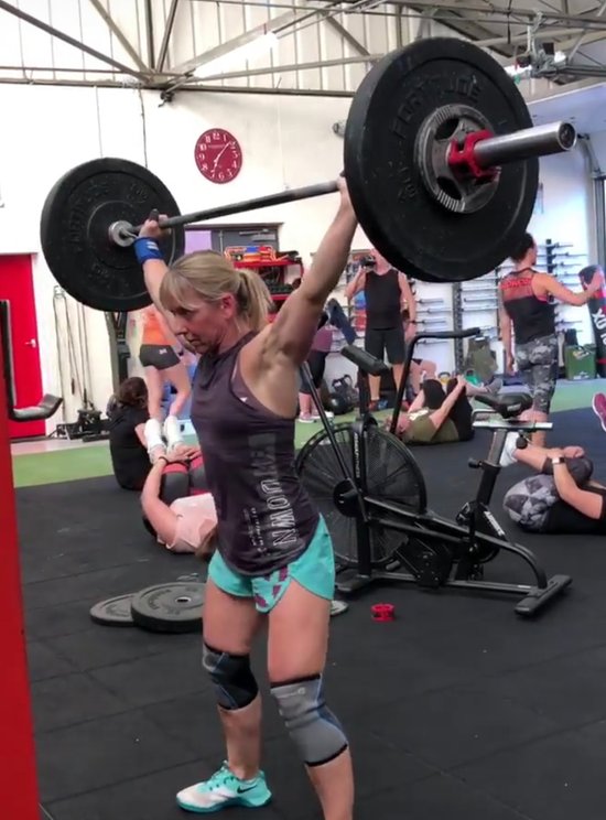 athlete doing overhead squats in gym
